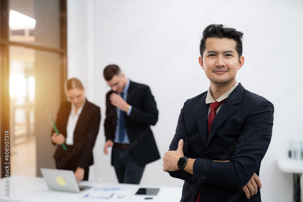 Portrait of Asian businessman happy multiethnic business women working together online on a laptop in corporate office. Portrait of Asian businessman happy multiethnic business women working together online on a laptop in corporate office.
