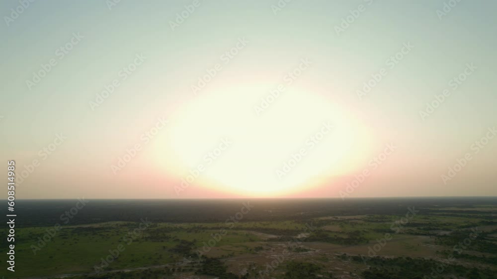 Aerial view of a river in the middle of the forest at sunset in the middle of Africa. Summer day in Chad after the rain season with green jungle next to the sand from a drone flying over the trees Aerial view of a river in the middle of the forest at sunset in the middle of Africa. Summer day in Chad after the rain season with green jungle next to the sand from a drone flying over the trees