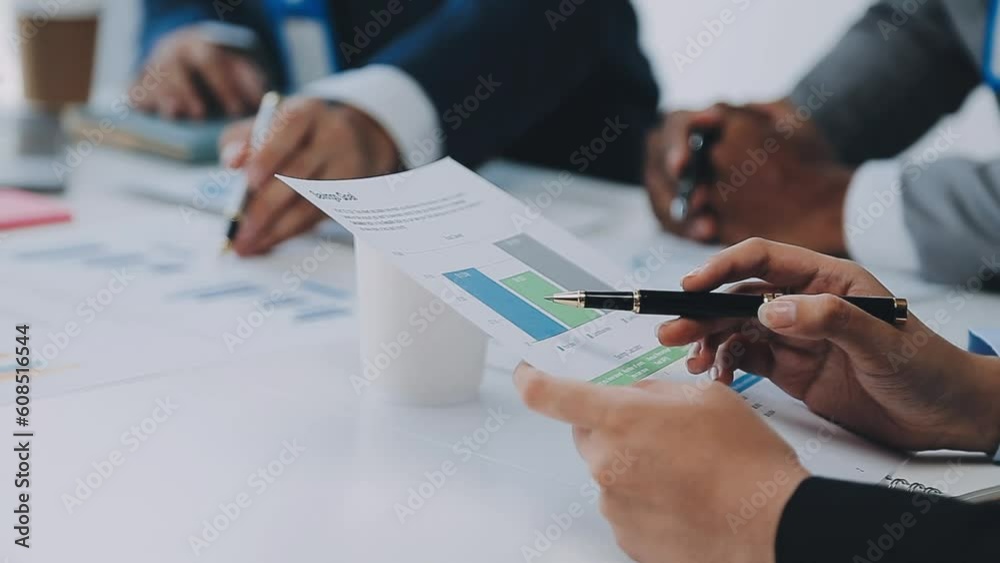 Group of coworkers in formal wear sitting at table in conference room and arguing about project of company development during meeting Group of coworkers in formal wear sitting at table in conference room and arguing about project of company development during meeting