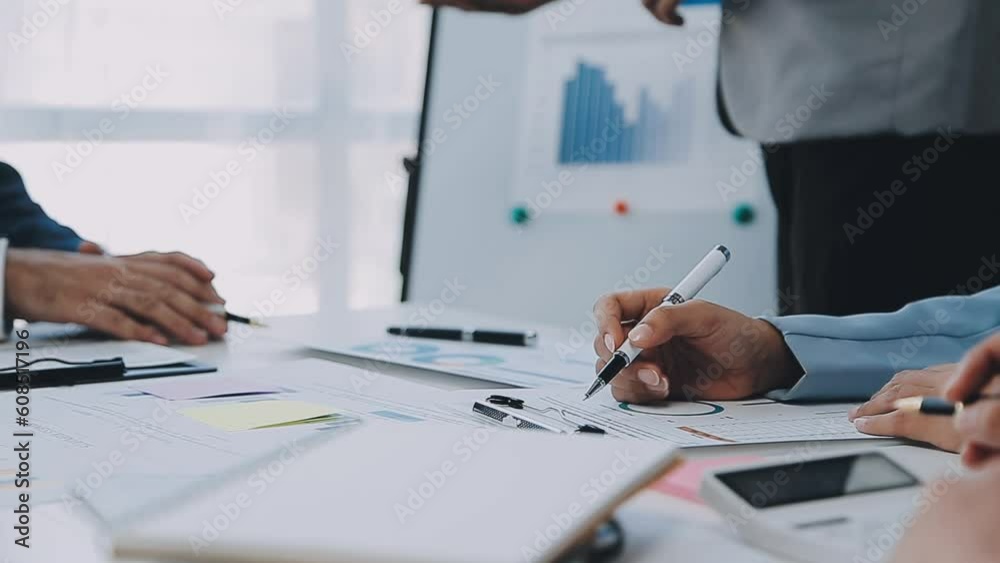 Group of coworkers in formal wear sitting at table in conference room and arguing about project of company development during meeting