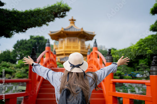 Asian tourist, cute woman with long hair are traveling in Hong Kong along with map and her camera with fun on her holiday, A temple in Hong Kong, concept travel. photo