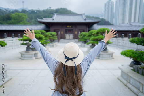 Photography Asian tourist, cute woman with long hair are traveling in Hong Kong along with map and her camera with fun on her holiday, A temple in Hong Kong, concept travel