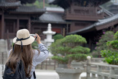 Asian tourist, cute woman with long hair are traveling in Hong Kong along with map and her camera with fun on her holiday, A temple in Hong Kong, concept travel. © maya1313