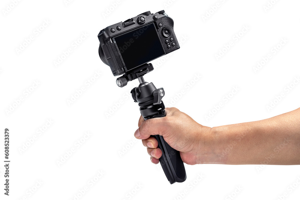 Human hand holding tripod with camera Human hand holding tripod with camera