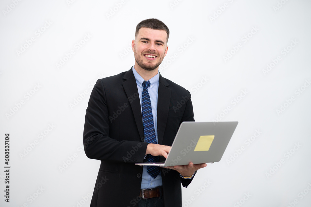A businessman wearing a suit and Smiling young handsome looking at the camera with laptop on white background. A businessman wearing a suit and Smiling young handsome looking at the camera with laptop on white background.