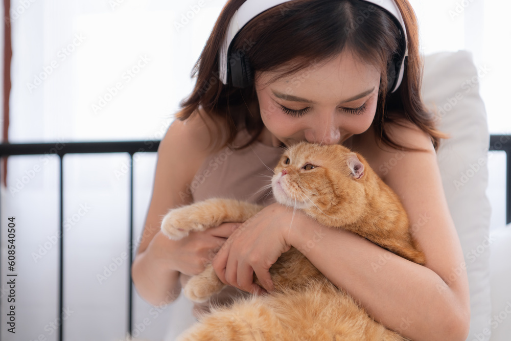 An intelligent Persian cat and owner playing together in bed An intelligent Persian cat and owner playing together in bed