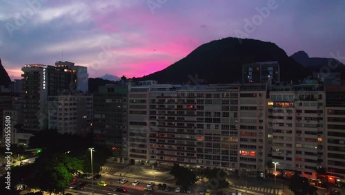 Sunset in Copacabana Main Street and Neighborhood Rio de Janeiro Gradient Pink Tones, Mountain and Main Street Traffic, Aerial Drone Shot photo
