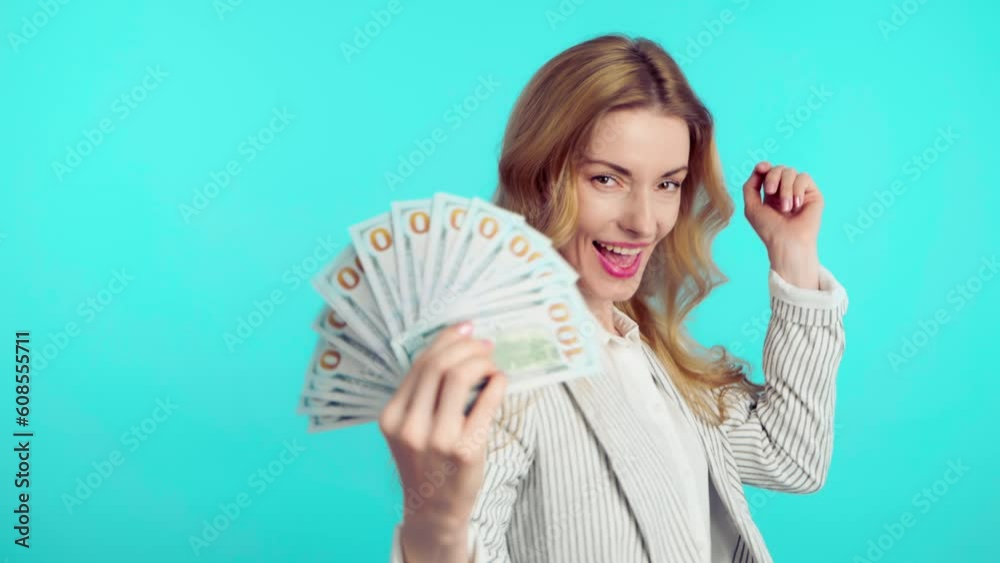 Dollars, money cash and winning prize woman celebration financial success. Excited rich businesswoman with lottery win for salary, bonus or business wealth or financial freedom on blue background Dollars, money cash and winning prize woman celebration financial success. Excited rich businesswoman with lottery win for salary, bonus or business wealth or financial freedom on blue background