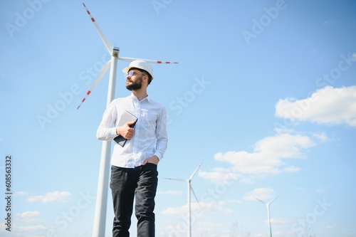 Engineer working at alternative renewable wind energy farm - Sustainable energy industry concept