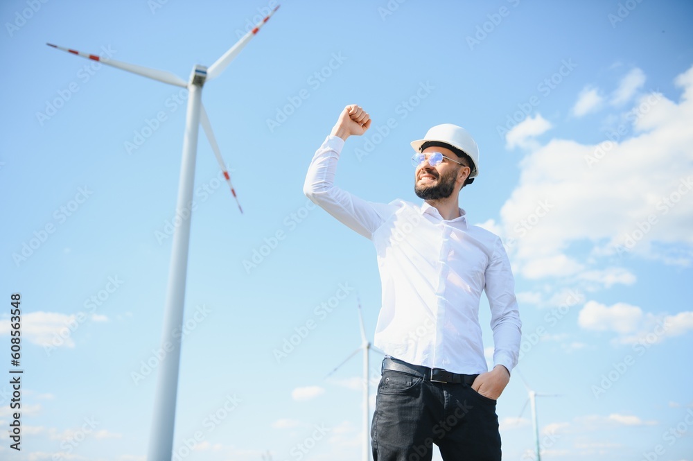 Engineer in field checking on turbine production Engineer in field checking on turbine production