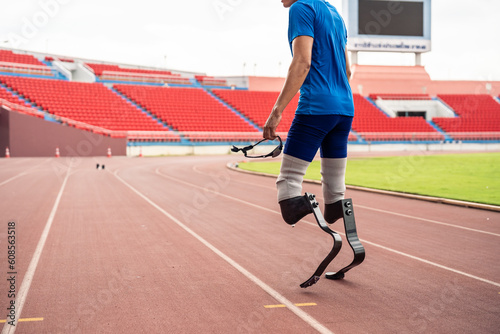 Close up of para-athletes disabled with prosthetic blades run at stadium