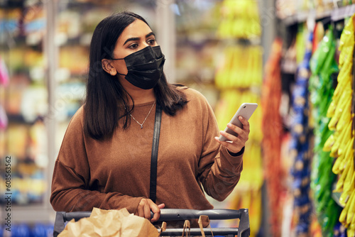Фотография Woman, phone and grocery checklist in shopping for food, luxury or product with face mask at supermarket
