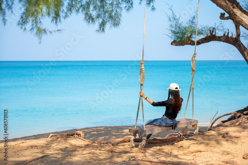 Traveler woman relaxing on swing, Leisure tourist travel summer holiday vacation trip at Mai Khao Beach, Phuket Thailand. © stpadcharin