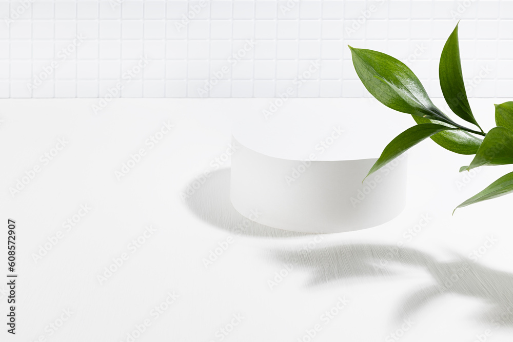 Summer abstract white stage with one round podium mockup for presentation cosmetic products, advertising, design in light interior, tiny mosaic tile, fresh tropical green leaves in sunlight, shadow.