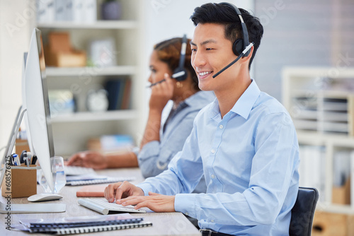 Business man, telemarketing and call center consultation in a office working on a computer. Smile, male worker and web support advice of a contact us employee with professional communication at job