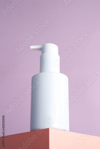 Blank white pump bottle on podium isolated