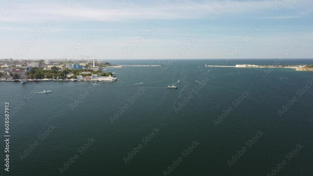 Sea bays of Sevastopol in Crimea during summertime in sunny weather. The aerial drone panoramic view an array of ships and boats, seaside tourism and travel destinations.