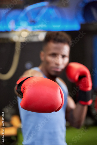 Selective Focus on Glove of Strong Black Male Boxer, Ready to Deliver a Powerful Punch in the Ring