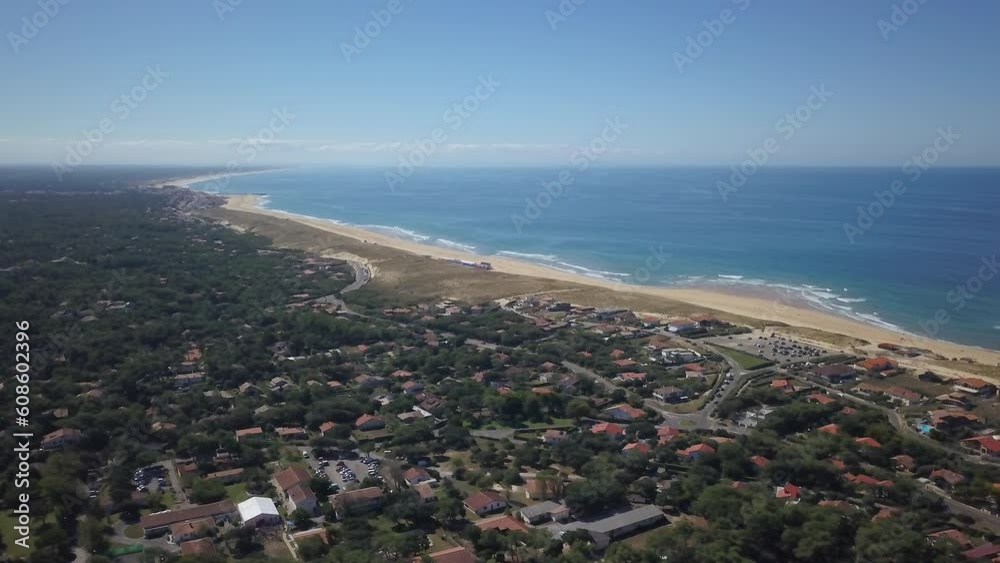Aerial drone cinematic Hoosegor Capbreton France Bay of Biscay Quiksilver Pro waves central beach over city town street cars roadway world surf league sunny mid day slowly circling right movement Aerial drone cinematic Hoosegor Capbreton France Bay of Biscay Quiksilver Pro waves central beach over city town street cars roadway world surf league sunny mid day slowly circling right movement