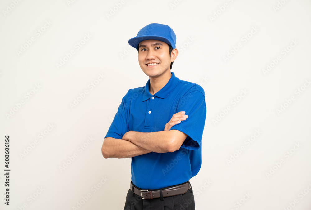 Happy asian man in blue uniform standing on isolated white background. Smiling male delivery service worker. Delivery courier and shipping service. Happy asian man in blue uniform standing on isolated white background. Smiling male delivery service worker. Delivery courier and shipping service.