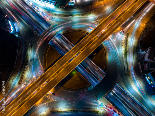 Expressway top view  Road traffic an important infrastructure  car traffic transportation above intersection road in city night  aerial view cityscape of advanced innovation  financial technology 