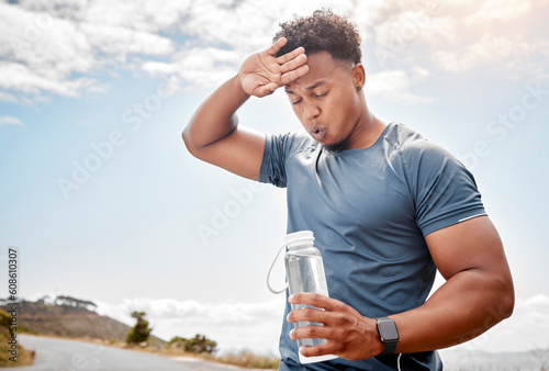 Fitness, outdoor and black man drinking water, tired and exercise with wellness, health and cardio training. Male person, guy or athlete outside, resting and liquid with practice, sweating and sports