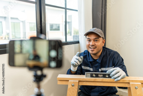 Technician is record video broadcasting live teaching how to use construction tools.