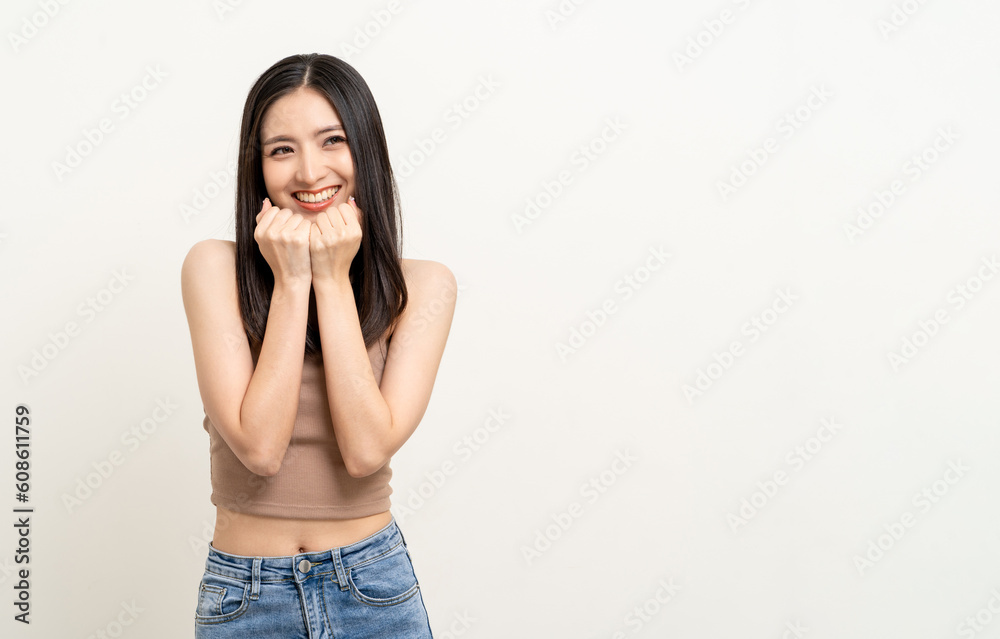 Beautiful smiling happy young asian woman age around 25 in brown shirt. Charming female lady standing pose on isolated white background. Asian cute people looking camera confident with white backdrop. Beautiful smiling happy young asian woman age around 25 in brown shirt. Charming female lady standing pose on isolated white background. Asian cute people looking camera confident with white backdrop.