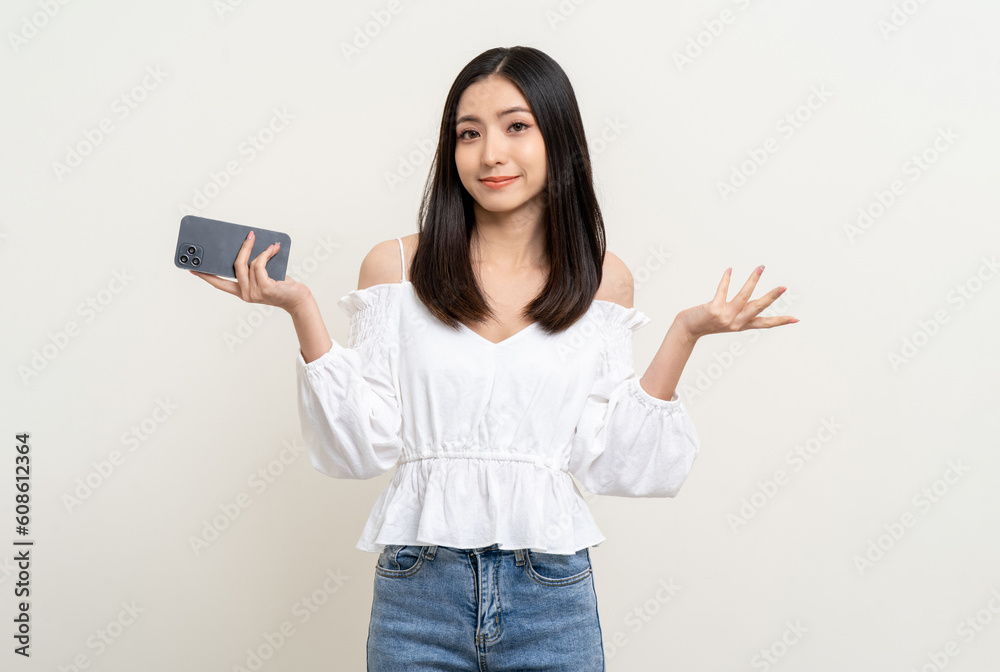 Pretty young asian woman using smartphone standing on isolated white background. Excited Beautiful young asian shopping online payment with mobile phone. Playing game on smartphone Pretty young asian woman using smartphone standing on isolated white background. Excited Beautiful young asian shopping online payment with mobile phone. Playing game on smartphone