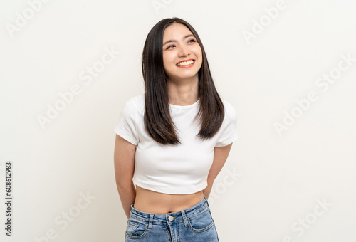 Beautiful young asian woman in white shirt. Charming female lady standing pose thinking on isolated white blank background. Asian cute people looking copy space for text advertise