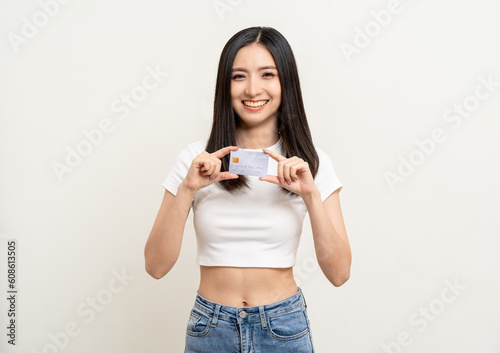 Portrait beautiful asian women standing pose holding credit card to shopping payment. Attractive Happy business woman with credit card financial concept. © Chanakon