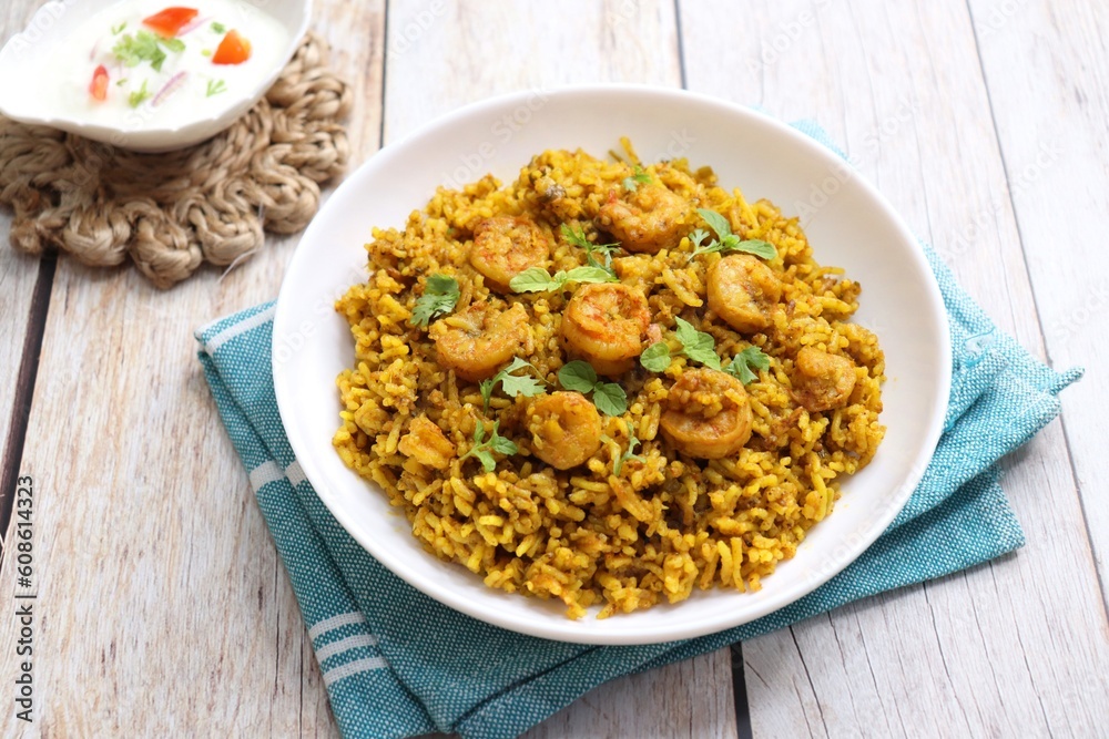 Prawns Biryani or shrimp Pulao. also called jheenga pilaf or jhinga biryani in India. known as Kolambi bhat in Marathi. Garnished with mint leaves, and coriander along with yogurt Raita. Copy space Prawns Biryani or shrimp Pulao. also called jheenga pilaf or jhinga biryani in India. known as Kolambi bhat in Marathi. Garnished with mint leaves, and coriander along with yogurt Raita. Copy space