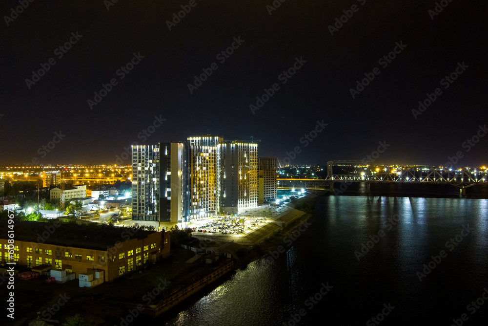 Astrakhan, Russia. Modern residential complex. Embankment of the river Volga. Night city lights. Aerial view