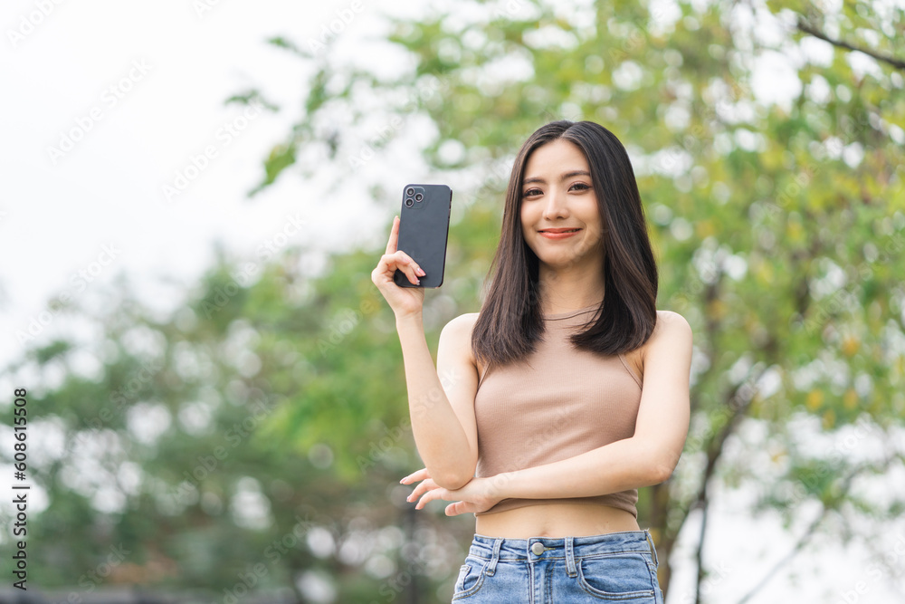 Happy feeling of beautiful Young woman using and text on smartphone. She shopping online. She smile very happy. Teenage girl reading news from mobile cell phone feeling excited. Happy feeling of beautiful Young woman using and text on smartphone. She shopping online. She smile very happy. Teenage girl reading news from mobile cell phone feeling excited.