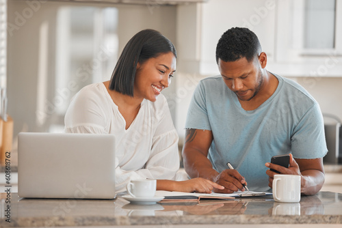 Couple, kitchen and paperwork for budget, finance or smile with laptop, phone and writing notes in home. Man, woman and documents with notebook, mortgage or computer for tax, compliance or investing