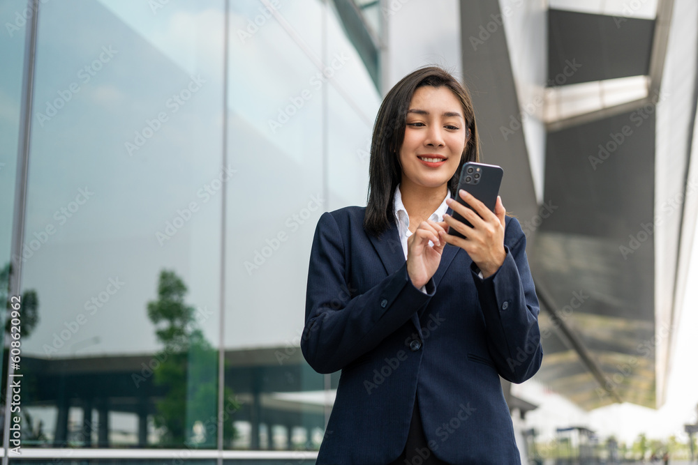 Portrait beautiful Businesswoman in suit with smartphone standing at the buildings downtown. Confident woman using cellphone. Executive Smart businessman Portrait beautiful Businesswoman in suit with smartphone standing at the buildings downtown. Confident woman using cellphone. Executive Smart businessman