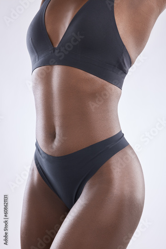 Body, beauty and stomach with woman in studio for nutrition, weight loss and diet. Fitness, wellness and abdomen muscle with closeup of female model on white background for self care and glow