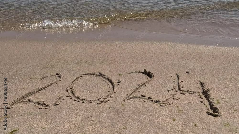 Happy new year 2024. The inscription on the sand. Numbers 2024 on the sea beach.