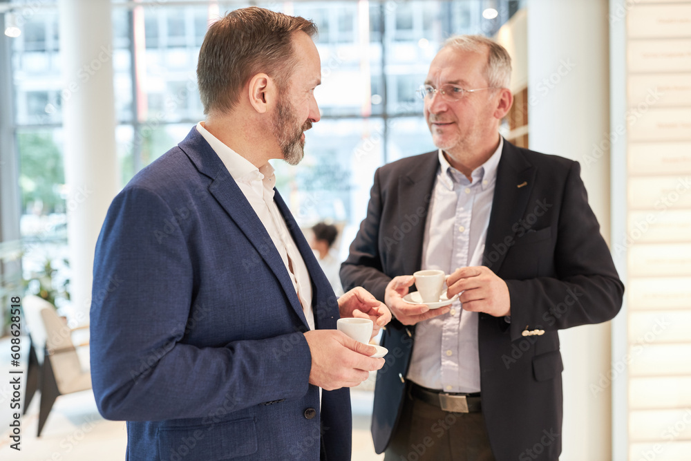 Two colleagues or business partners having small talk Two colleagues or business partners having small talk