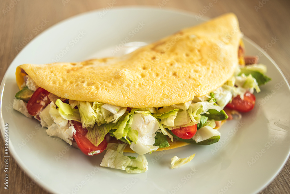 Homemade stuffed omelet with fresh vegetables and ham, with cottage cheese. Homemade stuffed omelet with fresh vegetables and ham, with cottage cheese.