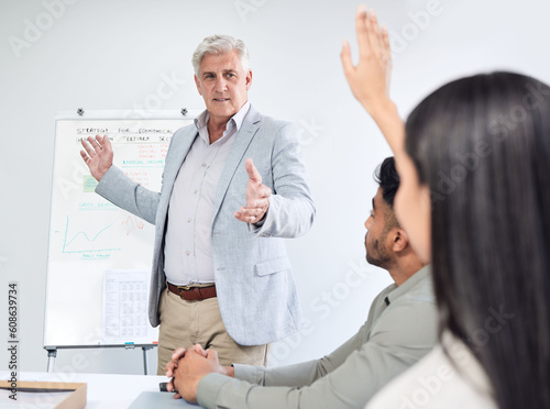 Questions, presentation and business man, leader or manager on whiteboard, mentorship and solution or ideas. Yes, conversation and people, CEO and employees hand in air for work meeting or learning