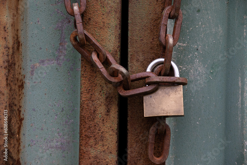 old rusty  chain and padlock on metal door © Tina Jenner