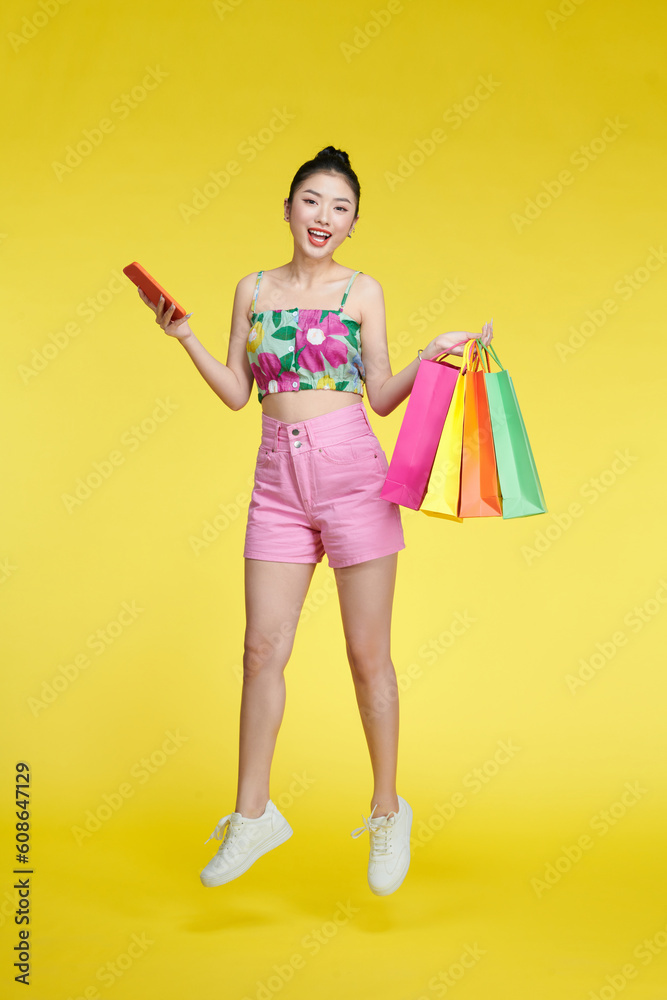 Full length photo of pretty positive lady hold store mall packages use telephone Full length photo of pretty positive lady hold store mall packages use telephone