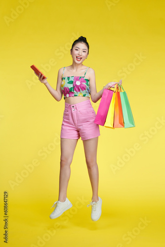 Full length photo of pretty positive lady hold store mall packages use telephone