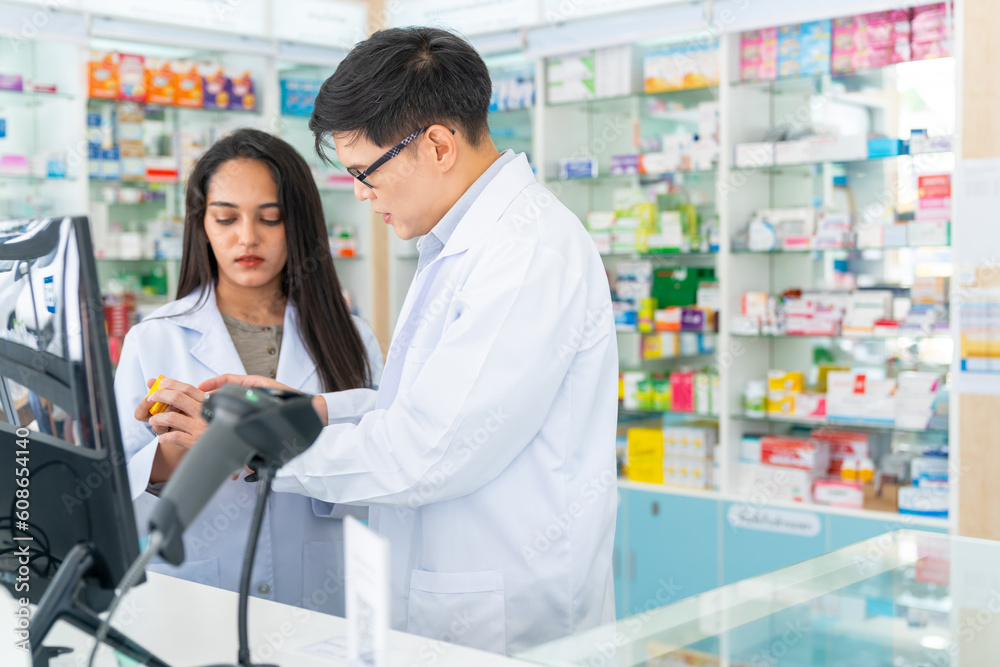 Medical pharmacy and healthcare business concept. Asian man and woman pharmacist working on digital tablet together checking medical product, drugs, medicine and supplements in modern drugstore.