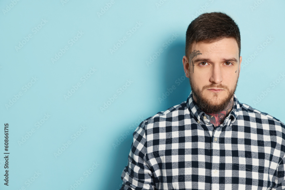 Portrait of handsome hipster man on light blue background. Space for text Portrait of handsome hipster man on light blue background. Space for text