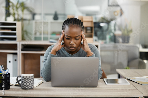 Business woman, laptop and headache in stress, burnout or depression in doubt, fail or mistake at office. Frustrated African female person or employee in anxiety or mental health problem at workplace