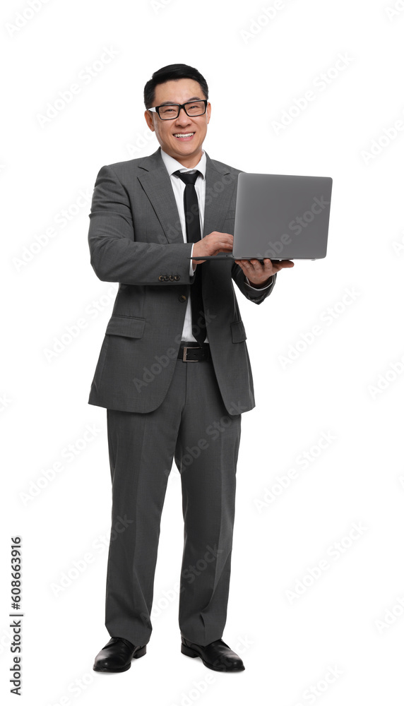 Businessman in suit working on laptop against white background