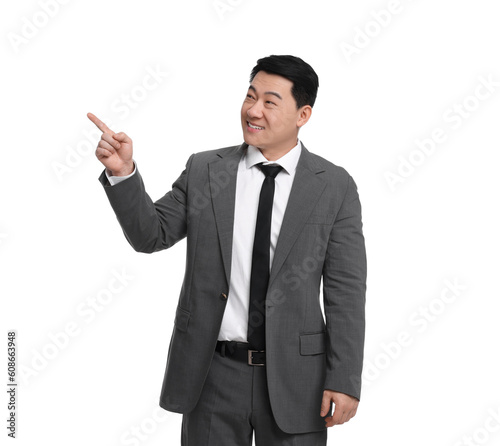 Businessman in suit pointing at something on white background