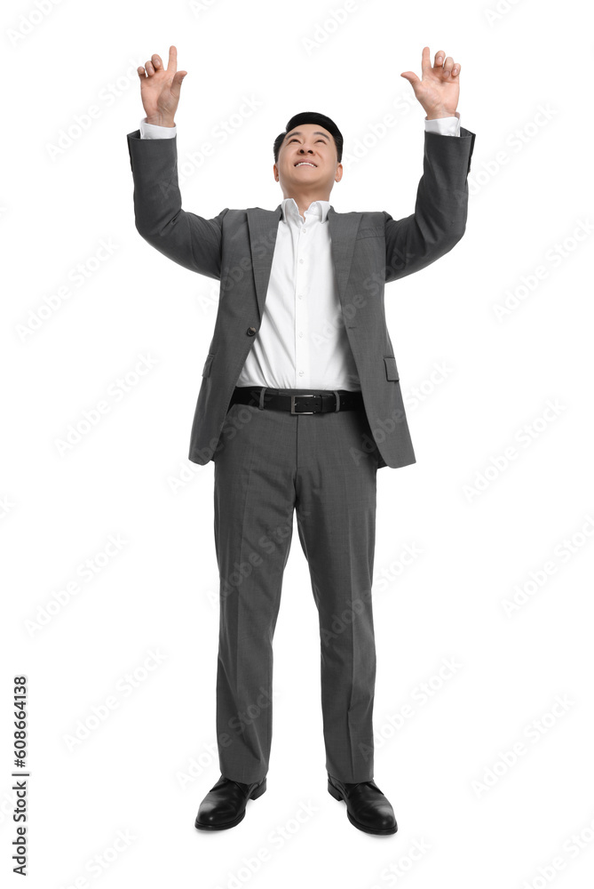 Businessman in suit posing on white background, low angle view Businessman in suit posing on white background, low angle view